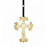 A gold-toned metal cross ornament with leafy vine details and a circular floral center, hanging from a black cord with a small white tag near the top, shown on a plain white background.
