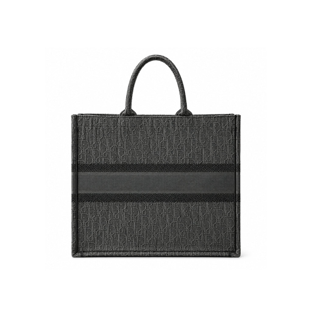 A black Dior tote bag featuring the signature Dior Oblique monogram pattern and a horizontal black stripe across the center, shown against a plain white background.