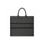 A black Dior tote bag featuring the signature Dior Oblique monogram pattern and a horizontal black stripe across the center, shown against a plain white background.