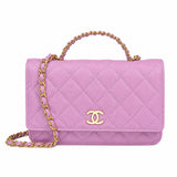 A pink quilted flap handbag with a gold-tone interwoven top handle and chain strap, featuring a gold interlocking CC logo on the front.