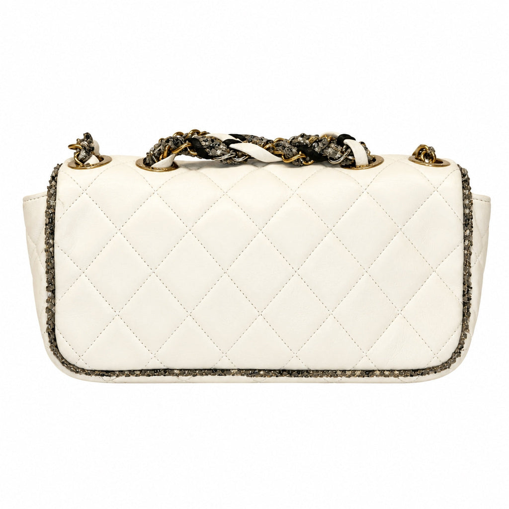 A quilted white leather shoulder bag with a snakeskin-patterned woven strap and gold-tone hardware, shown against a plain white background.