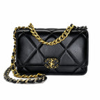 A black quilted leather Chanel flap bag with gold-tone chain strap and interlocking CC logo, shown on a plain white background.