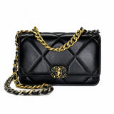 A black quilted leather Chanel flap bag with gold-tone chain strap and interlocking CC logo, shown on a plain white background.