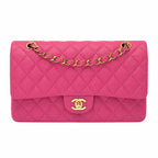A Chanel Classic Flap handbag in vibrant pink quilted leather with gold-tone hardware, featuring a diamond-quilted pattern, a top flap, and a gold interlocking CC turn-lock closure on a plain white background.