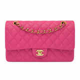 A Chanel Classic Flap handbag in vibrant pink quilted leather with gold-tone hardware, featuring a diamond-quilted pattern, a top flap, and a gold interlocking CC turn-lock closure on a plain white background.