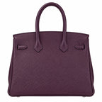 A dark purple pebbled leather handbag with double top handles, shown against a plain white background.