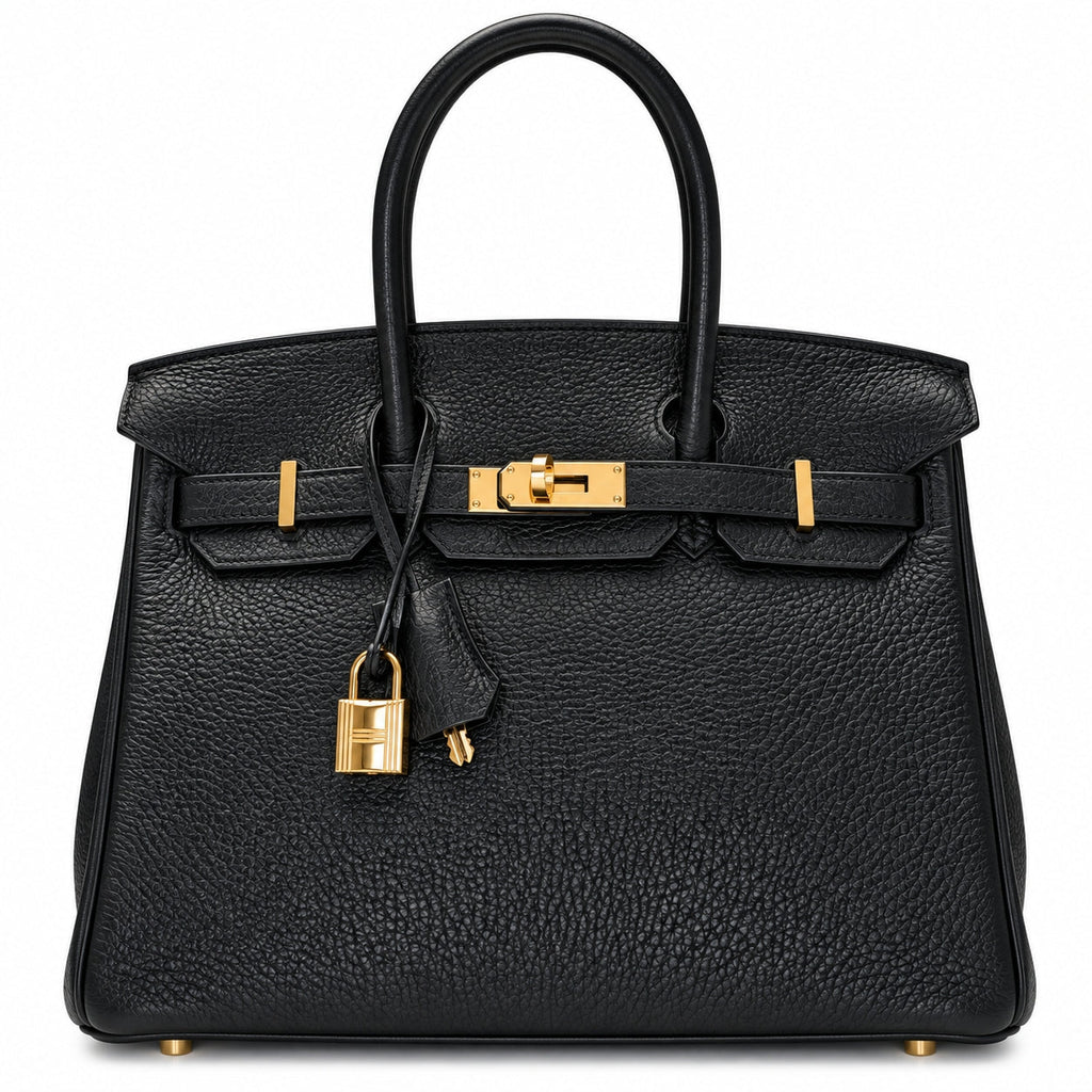 A black pebbled leather handbag with gold-tone hardware, featuring dual top handles, a front strap closure, and a hanging padlock clochette, photographed against a plain white background.