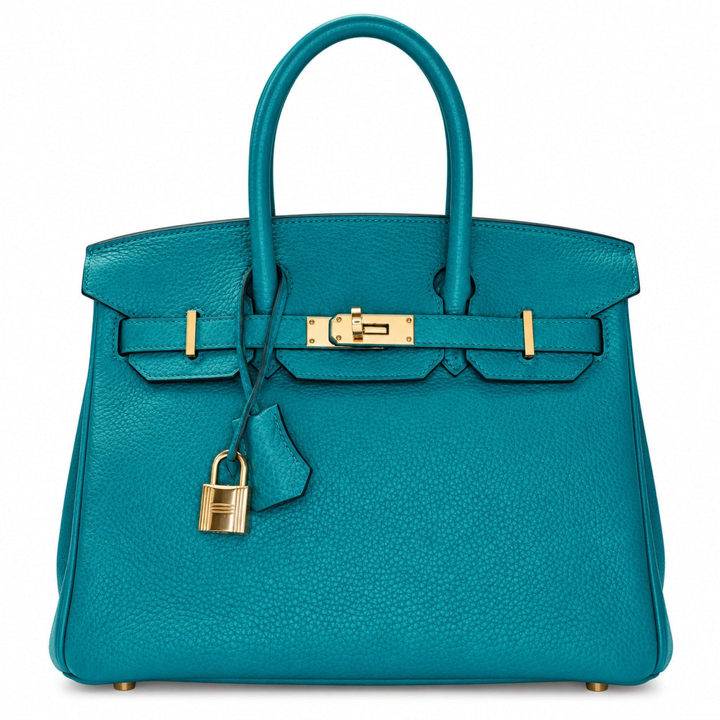 A teal pebbled leather handbag with gold-tone hardware, dual top handles, a front strap closure, and a hanging padlock, photographed on a clean white background.