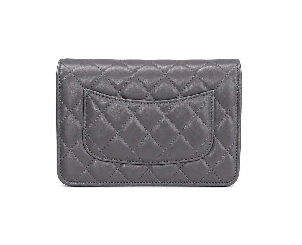 A gray quilted leather wallet with a silver-tone interlocking CC logo and a matching gray chain strap, shown on a plain white background.