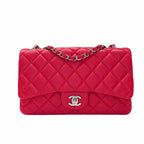 A red quilted leather shoulder bag with a diamond pattern, a front pocket, and a chain strap, shown against a plain white background.