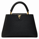 A black pebbled leather handbag with a structured silhouette, dual top handles, and a gold-tone Louis Vuitton monogram logo on the front, set against a plain white background.