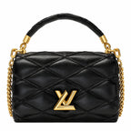 A black quilted leather handbag with a top handle, gold chain straps, and a gold-tone Louis Vuitton LV logo on the front, shown against a plain white background.