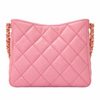 A pink quilted leather shoulder bag with a gold chain strap, shown against a plain white background.