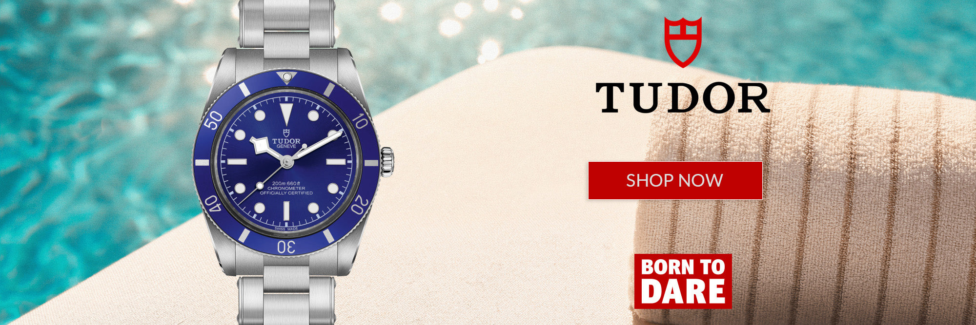 A Tudor watch with a silver metal bracelet and a blue dial, shown next to a poolside background with a rolled towel and promotional text including 'TUDOR', 'SHOP NOW', and 'BORN TO DARE'.